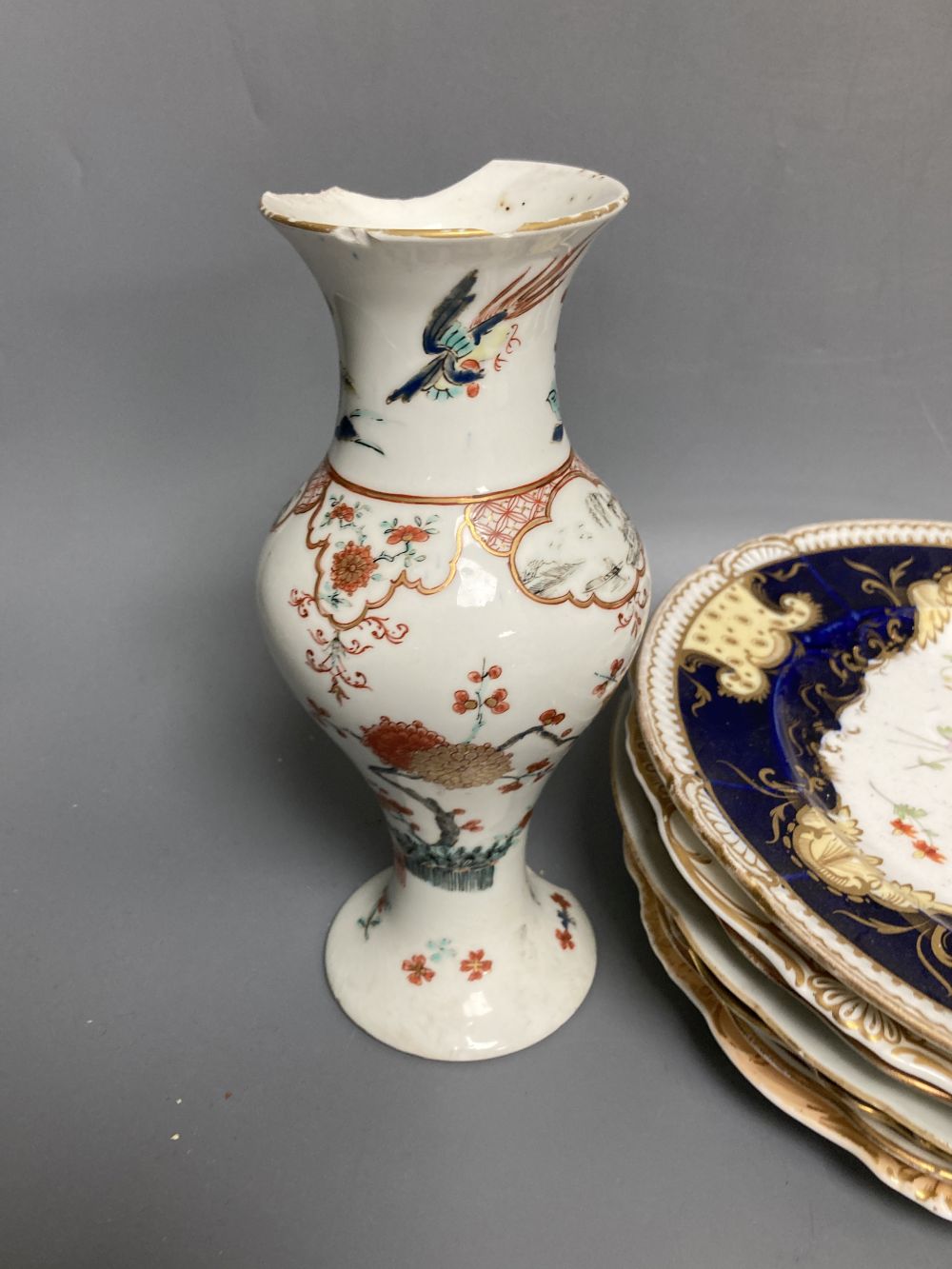 A Worcester Kakiemon vase, c.1765, a 19th century Paris porcelain plate and three tea bowls and 19th century English porcelain plates e